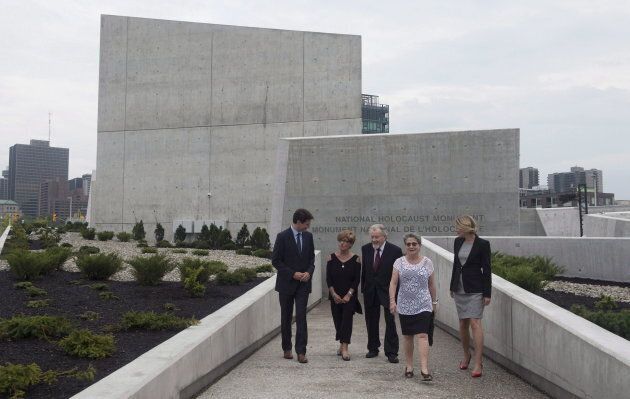 Prime Minister Justin Trudeau (left) speaks with holocaust survivors Georgette Brinberg, Philip Goldig and Eva Kuper as he and Minister of Canadian Heritage Melanie Joly visit the National Holocaust Monument in Ottawa, Sept. 27, 2017.