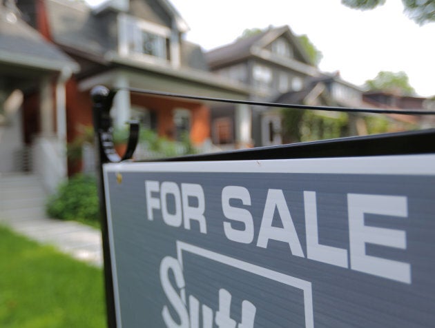 A sign advertises a house for sale in midtown Toronto, July 12, 2017. The Toronto Real Estate Board has been fighting for years against the Competition Bureau over how much real estate market data it should be making public.