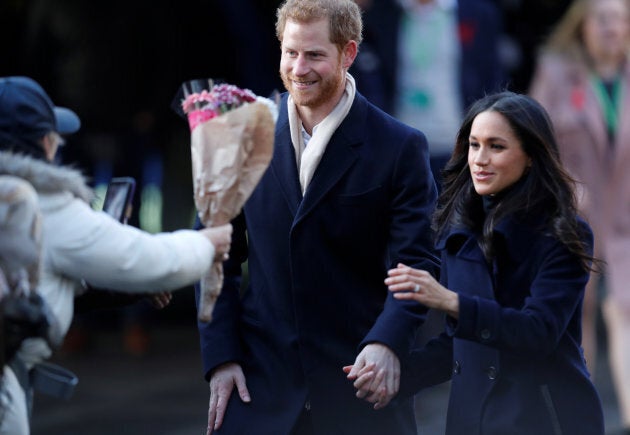 Prince Harry and Meghan Markle greet well wishers as they arrive at an event in Nottingham, Dec. 1, 2017.