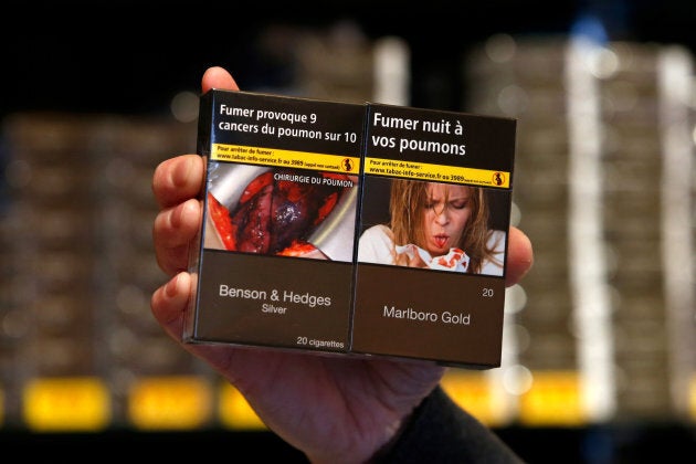 A tobacconist in France displays new plain packaging cigarettes wit health warnings on Jan. 2, 2017.