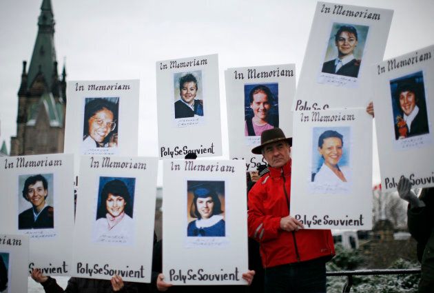 Demonstrators hold portraits of some of the victims of the Montreal Massacre during the National Day of Remembrance and Action on Violence Against Women rally on Parliament Hill in Ottawa, on Dec. 6, 2011.