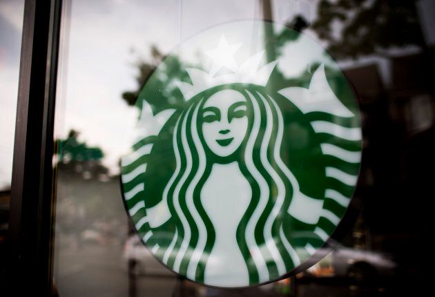 The Starbucks Corp. logo is displayed in the window of a store in Toronto, July 23, 2013.