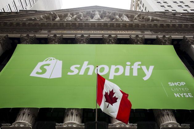 The logo of Shopify hangs behind the Canadian flag after the company's IPO at the New York Stock Exchange May 21, 2015.