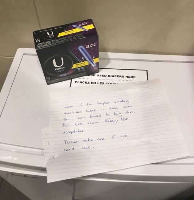 An anonymous note and a $15 box of tampons is shown in a women's washroom at the Calgary International Airport on Nov. 26, 2017.