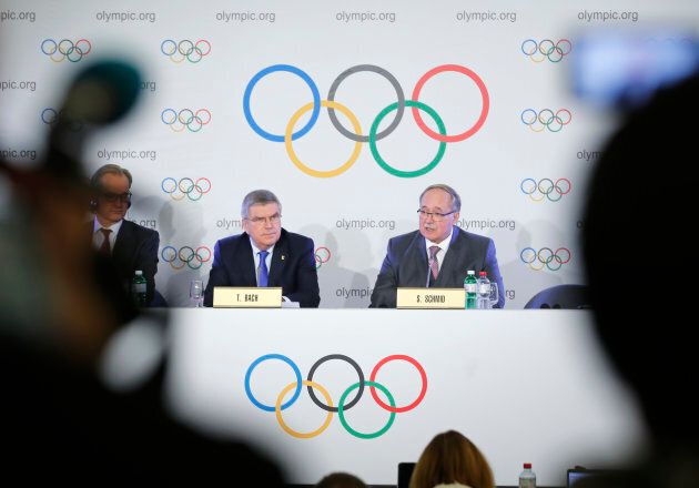 Samuel Schmid, chair of the IOC Disciplinary Commission, and Thomas Bach, president of the International Olympic Committee, attend a news conference after a meeting on sanctions for Russian athletes, in Lausanne, Switzerland on Dec. 5, 2017.