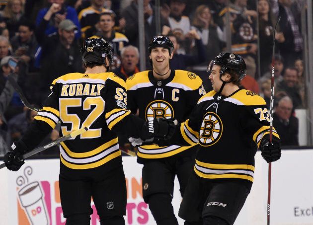 Boston Bruins center Sean Kuraly (52) reacts with defenseman Zdeno Chara (33) and defenseman Charlie McAvoy (73) after scoring a goal during the first period against the Pittsburgh Penguins at TD Garden, Nov 24, 2017 in Boston.
