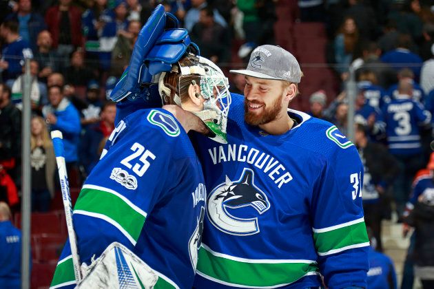 Anders Nilsson (31) of the Vancouver Canucks congratulates Jacob Markstrom (25) after their NHL game at Rogers Arena Dec. 2, 2017 in Vancouver.