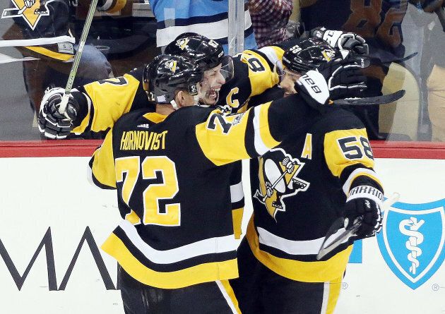 Pittsburgh Penguins center Sidney Crosby (87) celebrates his game winning goal with right wing Patric Hornqvist (72) and defenseman Kris Letang (58) against the Philadelphia Flyers at PPG PAINTS Arena, Nov. 27, 2017 in Pittsburgh.