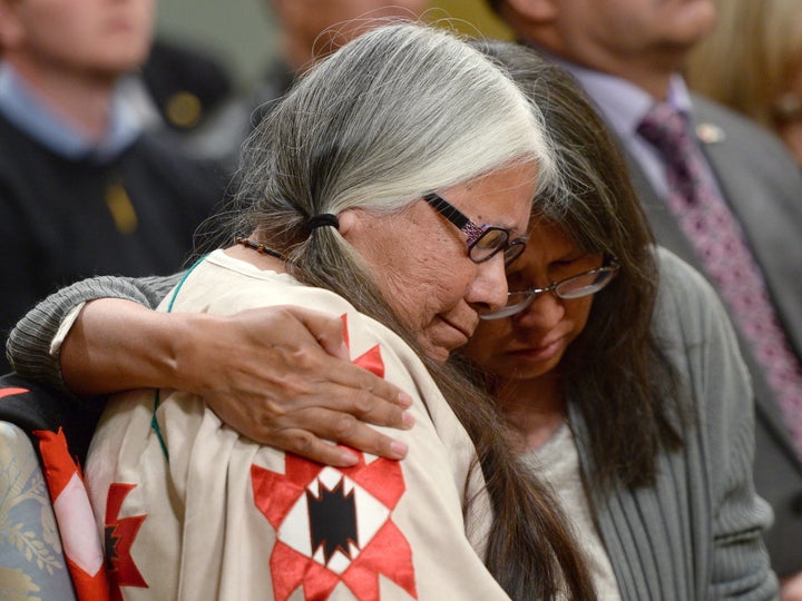 Residential school survivor Lorna Standingready is comforted by a fellow survivor in the audience during the closing ceremony of the Truth and Reconciliation Commission at Rideau Hall in Ottawa on June 3, 2015.