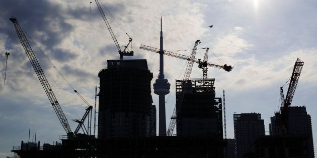 Condominiums under construction in Toronto, July 10, 2011. Data released on Friday showed urban construction starts for multiple-unit buildings, typically condos, surged 16.9 percent in November to 175,016 units, a record high even after a decades-long boom.