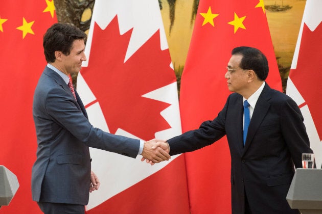 Prime Minister Justin Trudeau and Chinese Premier Li Keqiang shake hands during a news conference meeting at the Great Hall of the People in Beijing on Dec. 4, 2017.