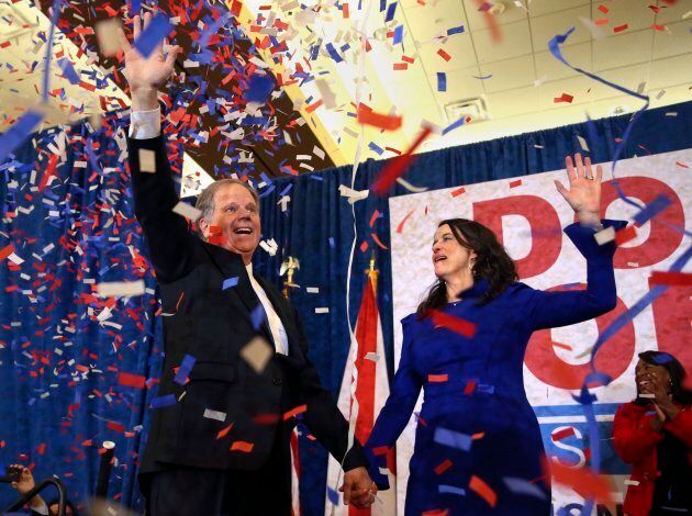 Democratic candidate for U.S. Senate Doug Jones and his wife Louise wave to supporters before speaking Dec. 12, 2017, in Birmingham, Ala.
