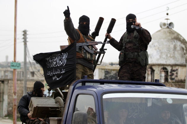 Members of al-Qaeda's Nusra Front drive in a convoy touring villages in the southern countryside of Idlib, on Dec. 2, 2014.