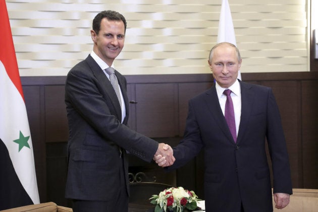 Russian President Vladimir Putin shakes hands with Syrian President Bashar al-Assad during a meeting in the Black Sea resort of Sochi, Russia, on Nov. 20, 2017.