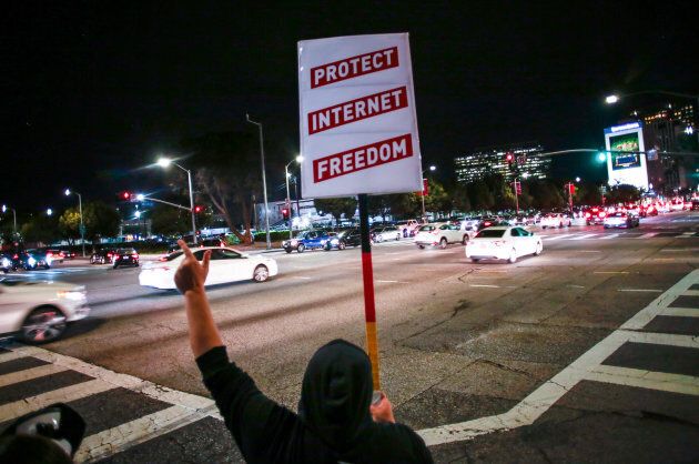 A net neutrality supporter protests the FCC's recent decision in Los Angeles, Ca. on Nov. 28, 2017.