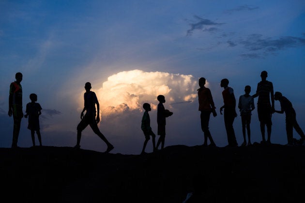 Children gather on a bank at sunset in the Protection of Civilians (PoC) site in Bentiu, South Sudan, Sunday 30 April 2017.