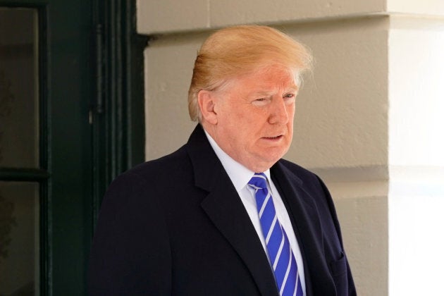 U.S. President Donald Trump walks out from the White House in Washington, D.C., before his departure to Camp David, on Dec. 16, 2017.