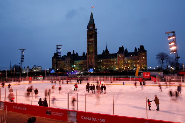 People skate on the Canada 150 ice rink on the front lawn of Parliament Hill in Ottawa on Dec. 7, 2017.