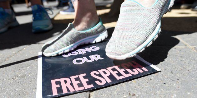 A woman stomps on a free speech sign after commentator Milo Yiannopoulos spoke to a crowd of supporters on the University of California, Berkeley campus on Sep. 24, 2017.