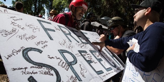 Jeff Barnes (left) of Alameda, Calif., invites people to sign a free speech sign during a pro-Donald Trump rally at Martin Luther King Jr. Civic Center Park in Berkeley, Calif., on April 27, 2017. The co-opting of the free speech mantle by conservatives has some progressives convinced that free speech itself is no longer worth defending.