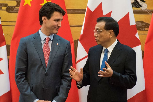 Chinese Premier Li Keqiang talks to Canadian Prime Minister Justin Trudeau during a signing ceremony meeting at the Great Hall of the People in Beijing, China Dec. 4, 2017.