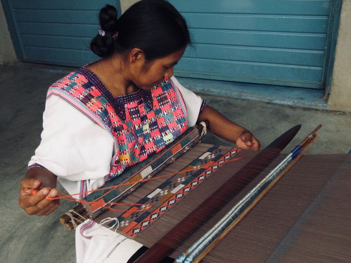 Anita, from Chiapas, creating the fabric for a cap using a backstrap loom.