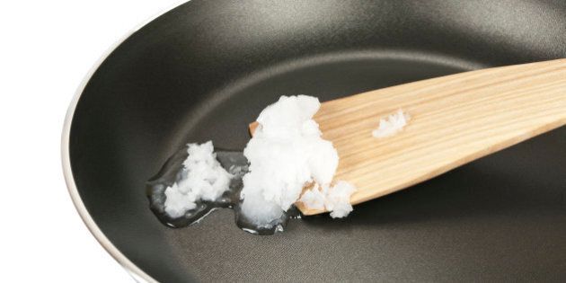 coconut oil in a pan and wooden spoon