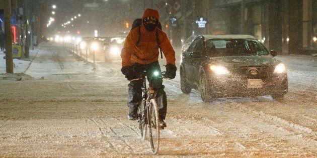 A cyclist commutes during a winter snowstorm in Toronto on Dec. 15, 2016.