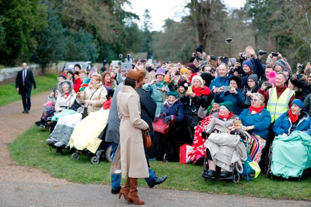 Prince Harry and actress Meghan Markle greet well-wishers as they leave after attending the Royal Family's traditional Christmas Day church service at St Mary Magdalene Church in Sandringham, on December 25, 2017.