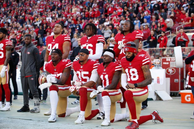 Eli Harold, Eric Reid, Marquise Goodwin, and Louis Murphy of the San Francisco 49ers kneel during the anthem as Solomon Thomas, Reuben Foster, and Adrian Colbert stand with them in support, prior to the game against the Tennessee Titans on Dec. 17, 2017.