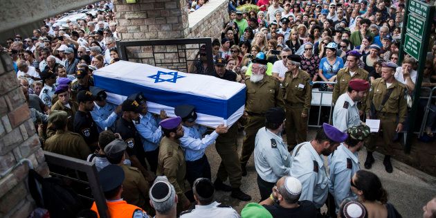 An honour guard caries the coffin of Israeli Lt. Hadar Goldin during his funeral on Aug. 3, 2014 in Kfar-saba, Israel. Goldin was thought to have been captured during fighting in Gaza, but was later declared killed in action by the Israeli Defence Force (IDF).