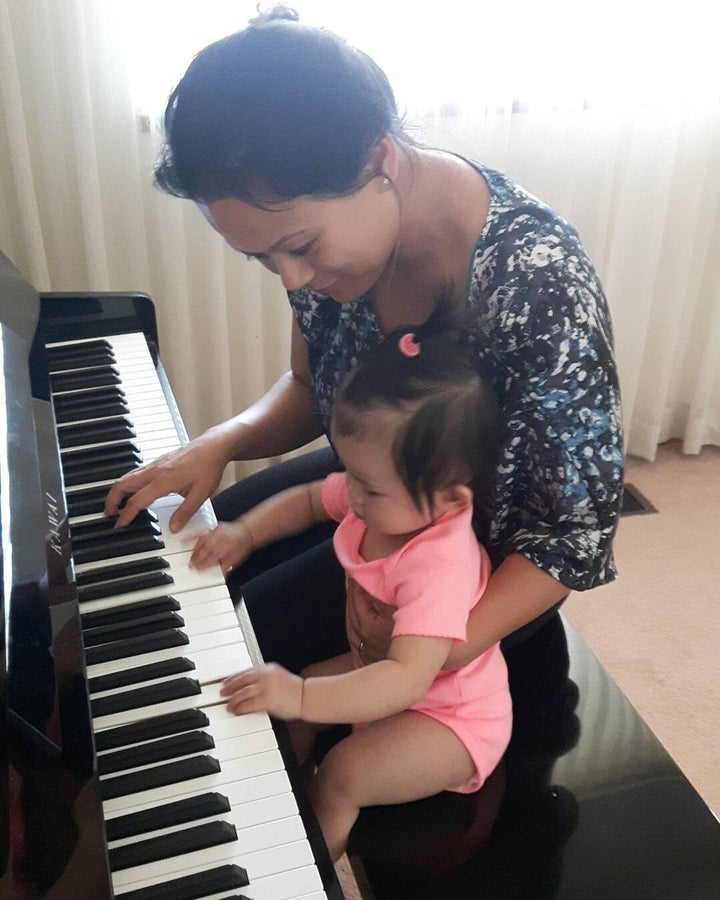 My daughter and I playing piano.