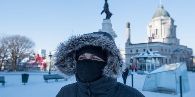 A woman walks through snow on a cold day in Quebec City on Wednesday.