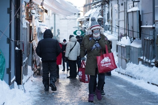 People walk down an icy street in Quebec City on Wednesday.