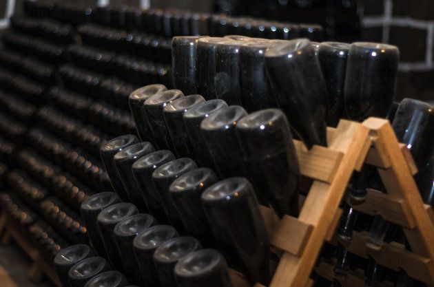 Traditional Champagne bottles being kept for secondary fermentation in the bottle in an underground cellar.