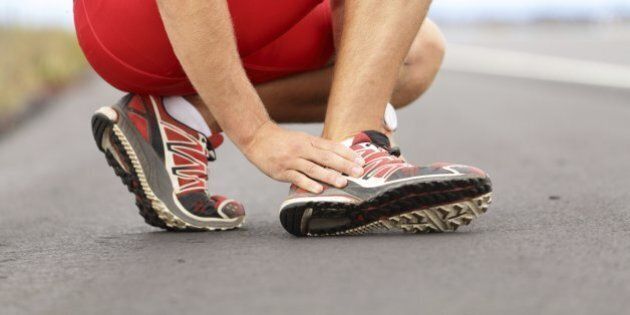 Broken twisted angle - running sport injury. Male runner touching foot in pain due to sprained ankle. Click for more:
