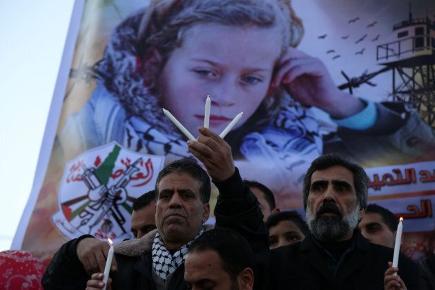 Palestinians hold candles during a support demonstration for Ahed Tamimi in Gaza City on Jan. 8, 2018.