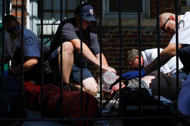 Medics and EMTs, along with firefighters, revive a man found unresponsive after overdosing on an opioid in the Boston suburb of Salem, Massachusetts, on Aug. 9, 2017.