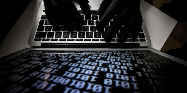 BERLIN, GERMANY - OCTOBER 22: Symbolic feature with topic online crime, data theft and piracy, here a close-up of a keyboard of a laptop with hands in black gloves, on October 22, 2013 in Berlin, Germany. (Photo by Thomas Imo/Photothek via Getty Images)