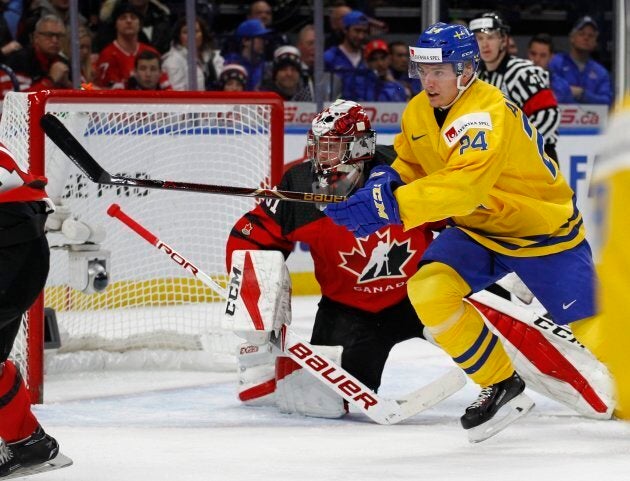 Sweden forward Lias Andersson skates past Canada goalie Carter Hart during the first period in the gold medal game of the world junior hockey championships on Friday.