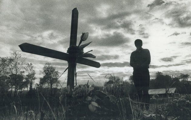 An Ojibwa person contemplates a family member's death at a cemetery at Grassy Narrows reservation near Kenora, Ont.