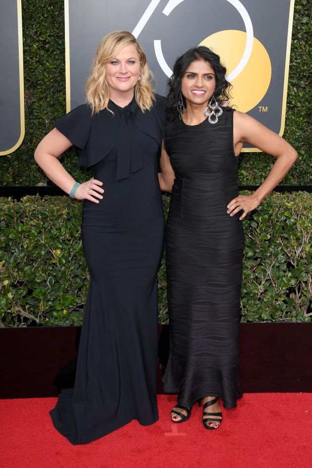Amy Poehler and activist Saru Jayaraman attend the 75th Annual Golden Globe Awards.
