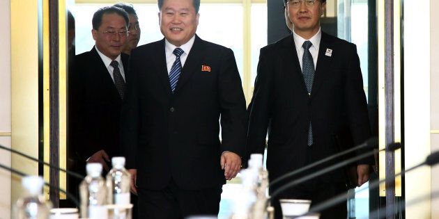 Ri Son Gwon, chairman of North Korea's Committee for the Peaceful Reunification of the Fatherland, center, and Cho Myoung-gyon, South Korea's unification minister, right, arrive for a meeting in the village of Panmunjom in the Demilitarized Zone (DMZ) in Paju, South Korea, on Tuesday, Jan. 9, 2018.