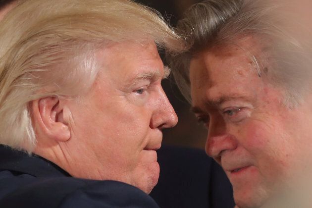 U.S. President Donald Trump talks to Steve Bannon during a swearing in ceremony for senior staff at the White House in Washington, D.C. on Jan. 22, 2017.