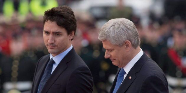 Former prime minister Stephen Harper and Prime Minister Justin Trudeau walk together during a ceremony on Oct. 22, 2015 at the National War Memorial in Ottawa.