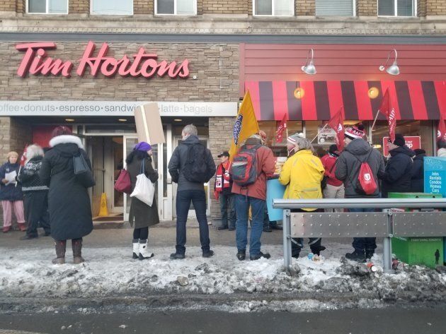 Protesters outside a Tim Hortons at the corner of Spadina and College streets in Toronto, Jan. 10, 2018.