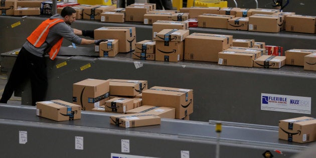 A worker prepares packages to be shipped inside of an Amazon fulfillment center in Robbinsville, N.J., Nov. 27, 2017.