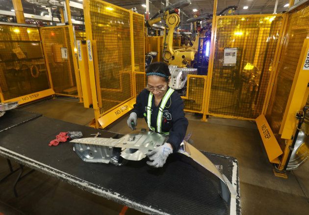 A worker checks welded part from auto weld assembly line at Alfield Industries, a subsidiary of Martinrea, one of three global auto parts makers in Canada, in Vaughan, Ont. April 28, 2017.