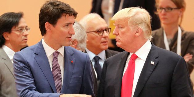 Prime Minister Justin Trudeau speaks with U.S. President Donald Trump at the beginning of the third working session of the G20 meeting in Hamburg, northern Germany, on July 8, 2017.