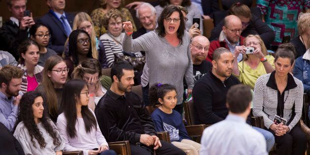 A woman heckles Prime Minister Justin Trudeau during a town hall event at Western University in London, Ont., on Jan. 11, 2018.